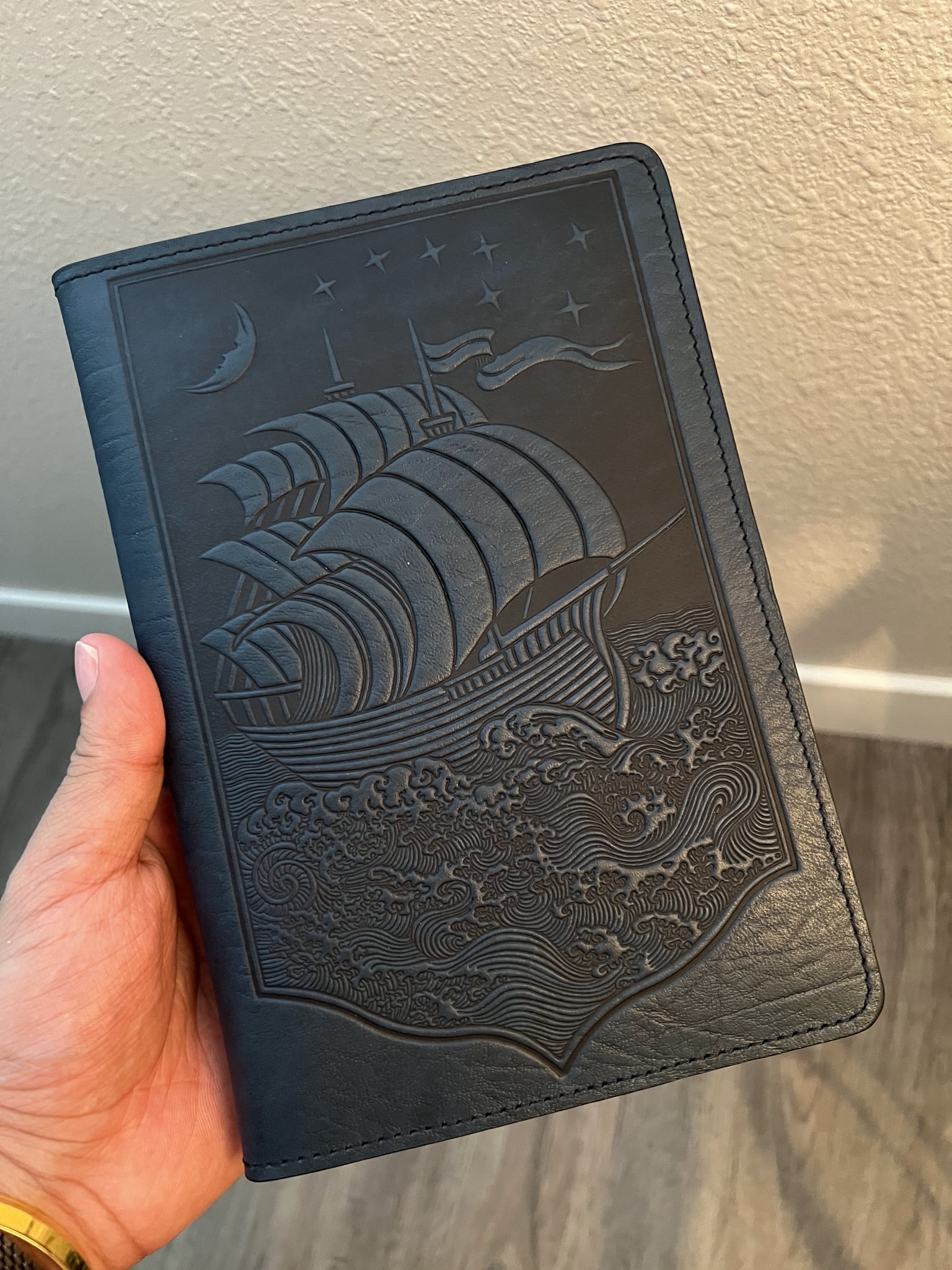 The embossed cover features a starry scene of a boat rocking in moonlit waves.